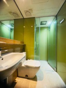 a bathroom with a toilet and a sink and a shower at Sky Suites KLCC Luxury Homestay in Kuala Lumpur +40 photos
