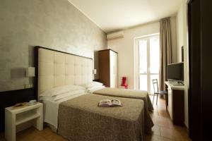Postel nebo postele na pokoji v ubytování Hotel Delizia + 16 fotografií