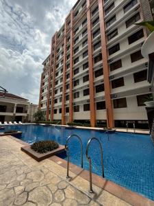 a swimming pool in front of a large building at Paseo Verde at Real in Manila