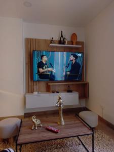 a living room with a tv and a coffee table at Modern studio in a tourist and university area in Bogotá +2 photos