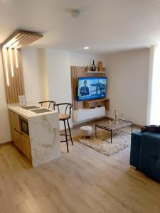 a living room with a couch and a tv at Modern studio in a tourist and university area in Bogotá