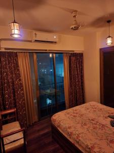 a bedroom with a bed and a large window at Apartment for Work Personal use in Mire