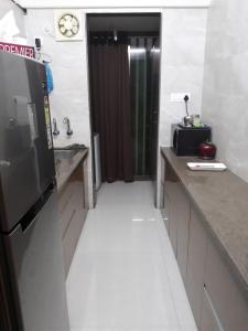 a kitchen with a counter and a television and a door at Apartment for Work Personal use in Mire