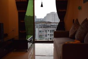 a living room with a couch and a large window at Apartment for Work Personal use in Mire