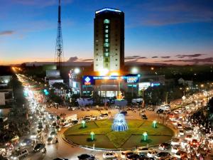 a city at night with a building and a fountain at BMC Ha Tinh hotel in Ha Tinh