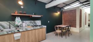 a kitchen with a counter and a table with chairs at Spacious apartment in Buga, super central in Buga