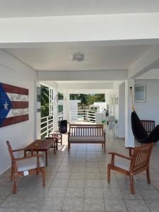 een woonkamer met banken en een vlag aan de muur bij White House Paradises in Cabo Rojo
