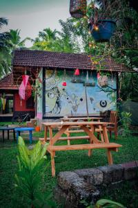 a picnic table in front of a house with a mural at Munroe Paradise in Munroe Island