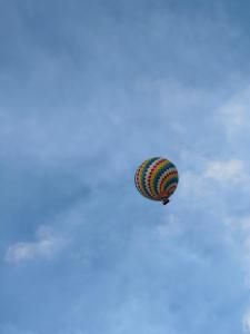 a colorful kite is flying in the sky at Le Jardin 2 Organique Guesthouse Vang Vieng in Vang Vieng