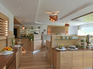 a large kitchen with wooden cabinets and a counter top at Biohof Naturzeit Faaker See in Drobollach am Faakersee