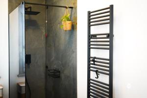 a bathroom with a shower with a glass door at Netik Apartment Cortona - Tuscan Vineyard escape in Cortona