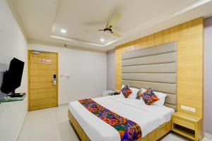 a bedroom with a bed and a television in it at FabHotel Prime Veeraj Suites- Nr Skyview10, Lumbini Avenue, Gachibowli in Hyderabad