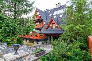 a large house with a gambrel roof at Rezydencja Na Szymoszkowej in Zakopane