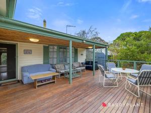 una terraza con sillas, un sofá y una mesa en Glyndon Family Getaway, en Ventnor
