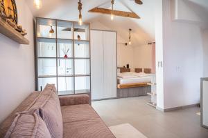 a living room with a couch and a bedroom at Hill Stars House in Straža