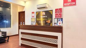 a fast food restaurant with a counter and a sign at Hotel Surya Inn in Jāmb