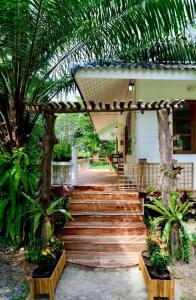a wooden stairway leading to a house with a woodenvisor at Kood Life in Ko Kood