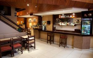 a restaurant with a bar and some tables and chairs at Kamana Hotel in Lima
