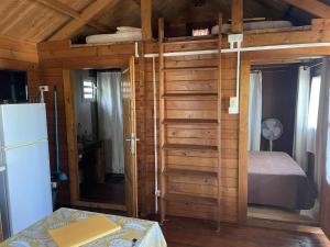a room with a bed and a room with a refrigerator at Les Bungalows les Vanilliers, Sud Sauvage avec piscine in Saint-Joseph +113 photos