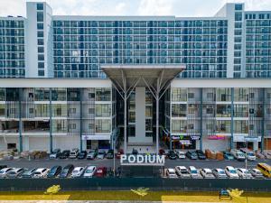 a parking lot in front of a large building at Podium apartments in Kuching