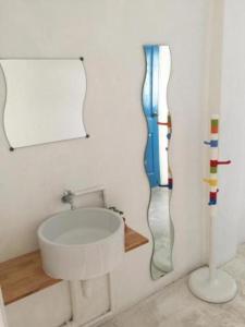a bathroom with a sink and a mirror at The Sugar Hostel in Nonthaburi