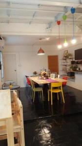 a kitchen with a table and chairs in a room at The Sugar Hostel in Nonthaburi