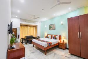 a hotel room with a bed and a desk at FabHotel The Silken Stay in Gurgaon