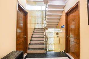 a staircase in a building with two doors at FabHotel The Silken Stay in Gurgaon