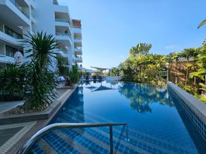 a view of a swimming pool at a resort at 2 Bedrooms Apartment pool access in Ban Lum Fuang