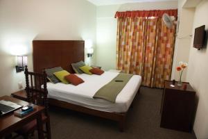Postel nebo postele na pokoji v ubytování Kamana Hotel