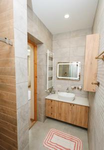a bathroom with a sink and a mirror at villa aragvi in Aragvispiri