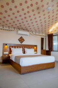 a bedroom with a large bed in a room at Stayguru Road to Heaven Resort in Kunria