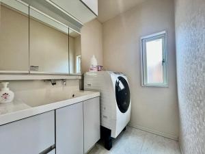 a laundry room with a washing machine and a window at Near Ikebukuro! 2min to Kita Ikebukuro Large House in Tokyo +61 photos