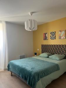 a bedroom with a large bed with a blue blanket at Sapin in Les Piards +36 photos