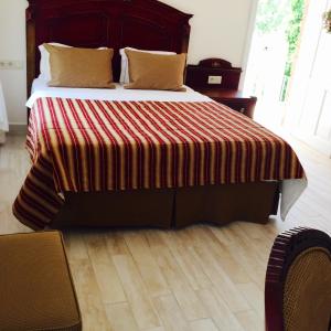 a bedroom with a large bed with a striped blanket at Losta Sahil Evi 2 in Selimiye