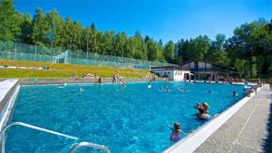 a large swimming pool with people in the water at Haus am See in Litschau
