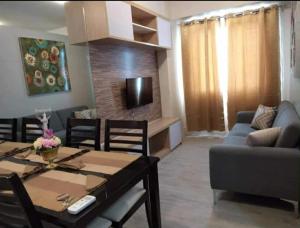 a living room with a table and a couch at Sweet Escape 311 at Amaia in Bacolod +4 photos