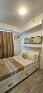 a bedroom with a large bed in a rv at Sweet Escape 311 at Amaia in Bacolod