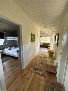 a hallway with a bedroom and a bed in a room at Holiday home Kolmårdsgården in Kolmården
