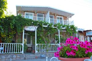 a house with pink flowers in front of it at Losta Sahil Evi 2 in Selimiye