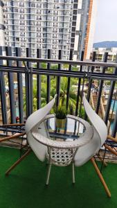 a table and two chairs on a balcony at MZS Studio Swiss Garden R in Kuantan