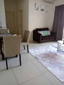 a living room with a couch and a table at MZS Studio Swiss Garden R in Kuantan