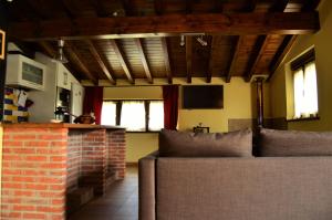 a living room with two couches and a brick fireplace at La Galayca in El Barcenal