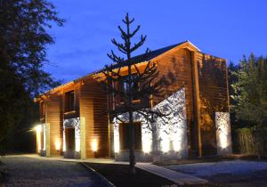 a building with a tree in front of it at La Araucaria in Villa La Angostura
