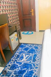 a room with a blue rug on the floor and a door at 9ja Luxury Life Suites in Port Harcourt +5 photos