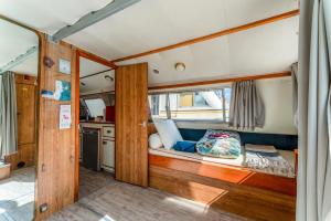 a small room with a bed in the back of a boat at Penichette Odyssey Croisieres in Bellegarde