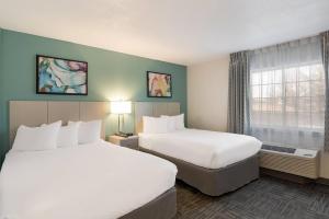 a hotel room with two beds and a window at MainStay Suites Orlando Altamonte Springs in Orlando +16 photos