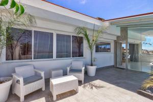 a patio with chairs and a table and windows at Panoramic Ocean Mountain View 3 in Adeje