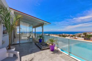 a balcony of a house with a swimming pool at Panoramic Ocean Mountain View 3 in Adeje