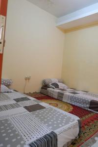 a room with two beds in a room at PW Homestay in Sleman